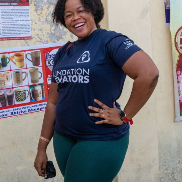 A smiling Foundation Elevators volunteer before the Widows in Need distribution
