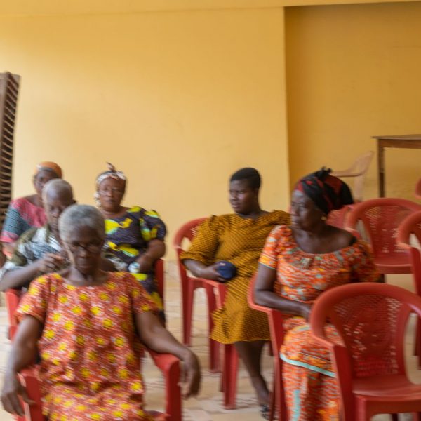 Beneficiaries seated together at the Abiriw community centre