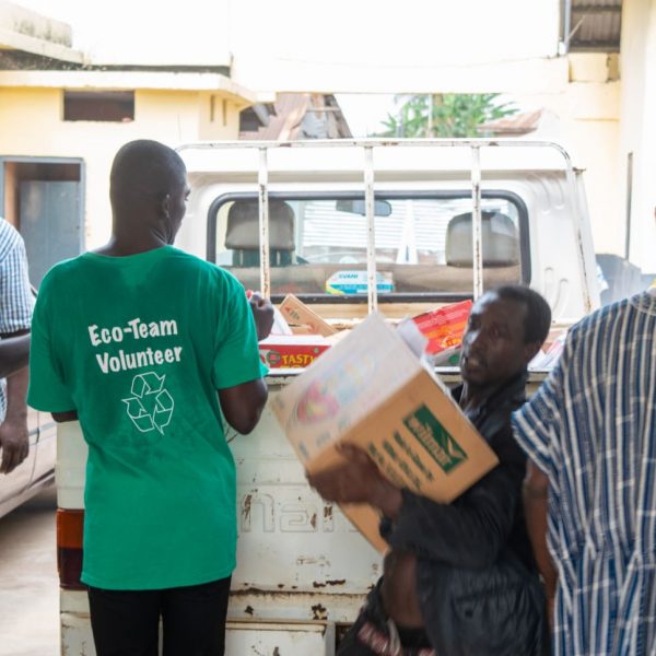 Volunteers unloading cartons of supplies from the delivery truck
