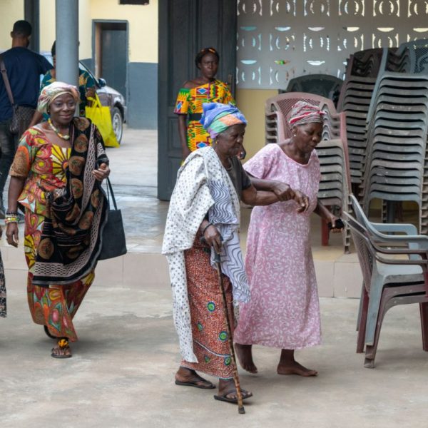 Widows walking into the community centre for the distribution