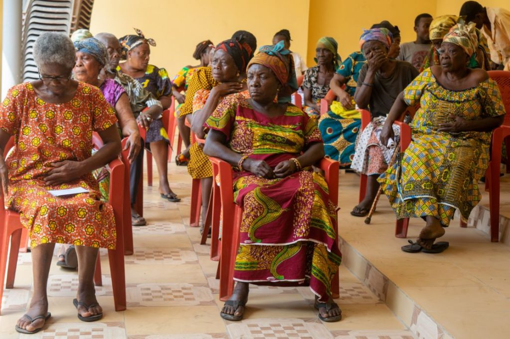 Rows of widows seated together at the Abiriw community centre