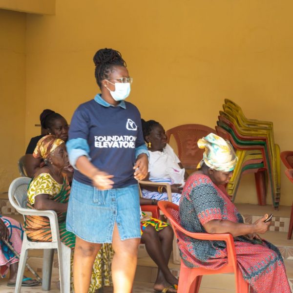 A Foundation Elevators volunteer speaking with beneficiaries during distribution