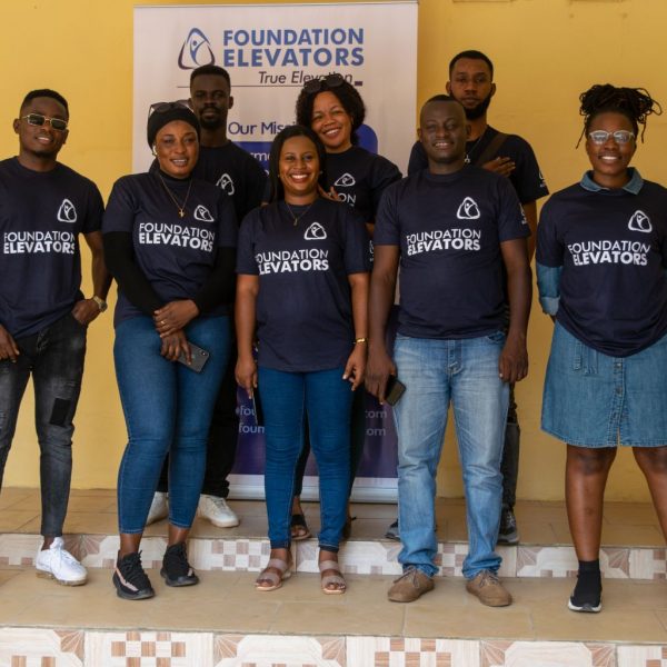 The Foundation Elevators team in front of the organisation banner