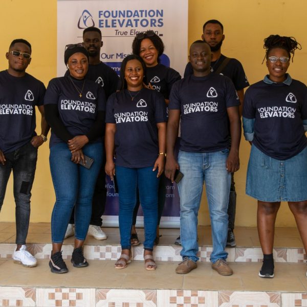 Foundation Elevators volunteers photographed beside the mission banner