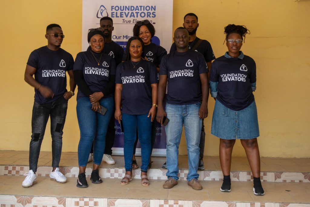 The Foundation Elevators volunteer team in front of the True Elevation banner