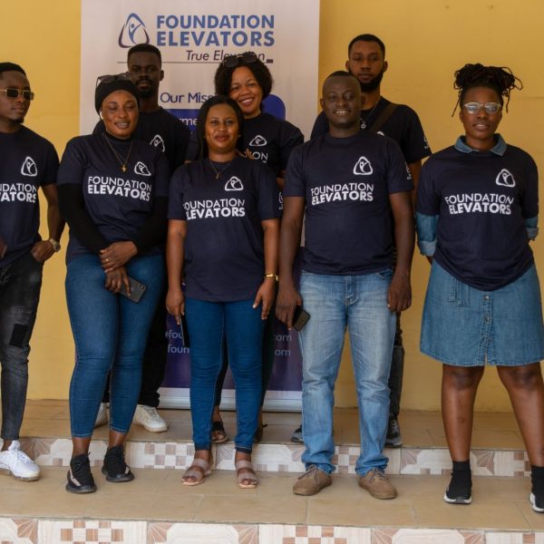 The Foundation Elevators volunteer team in front of the True Elevation banner